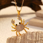 Rhinestone crab pendant necklace with gold-tone crab charm and black eye accents