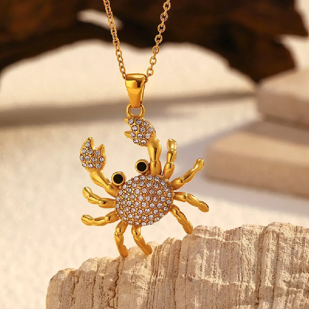 Rhinestone crab pendant necklace with gold-tone crab charm and black eye accents
