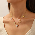 Gold-tone heart, butterfly and flower pendant necklace with pearl accents