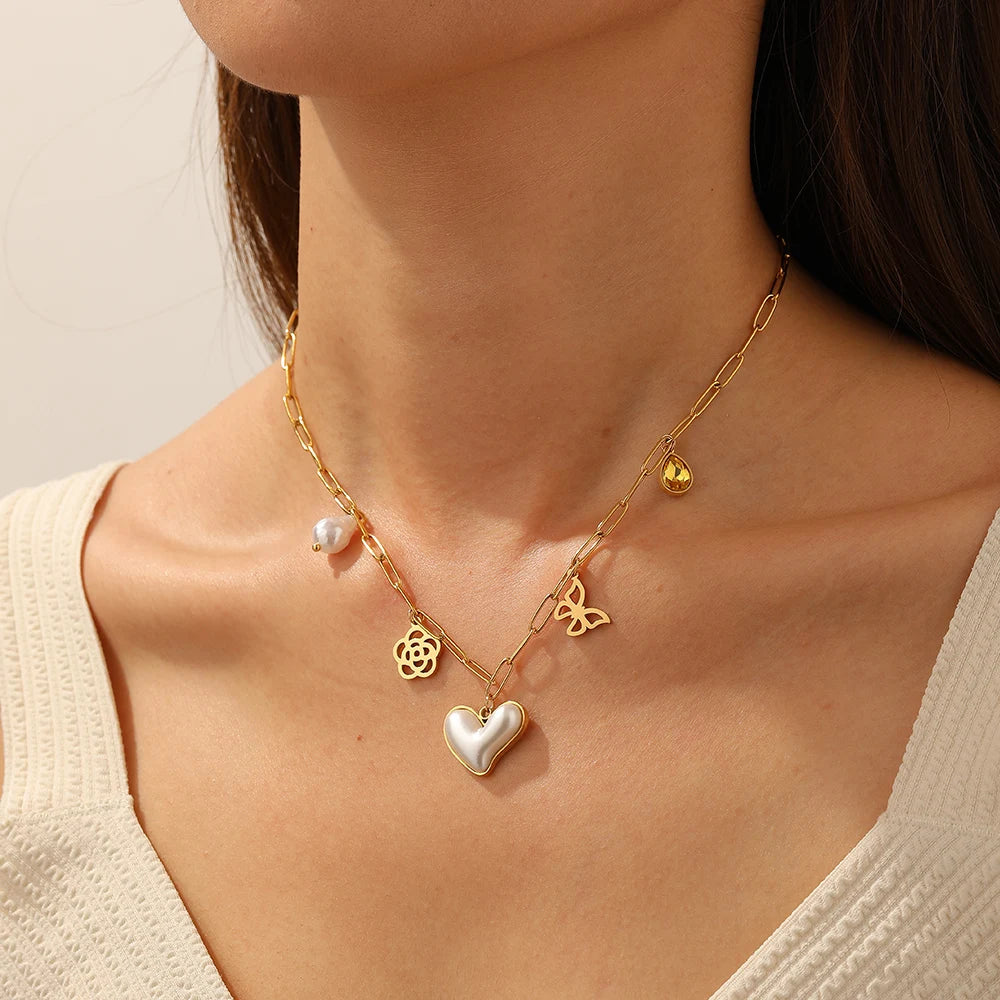 Gold-tone heart, butterfly and flower pendant necklace with pearl accents