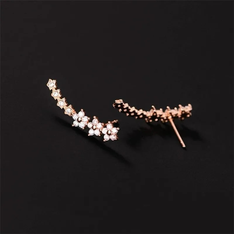 Rhinestone ear climber earrings in silver and rose-gold tones with daisy clusters