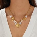 Gold-tone ocean charm necklace with pearls and crab, turtle, shell pendants
