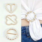 Scarf brooch clip set: pearl circle and heart-shaped rhinestone clips on white fabric