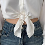Heart-shaped pearl scarf knot brooch clip on a white fabric knot