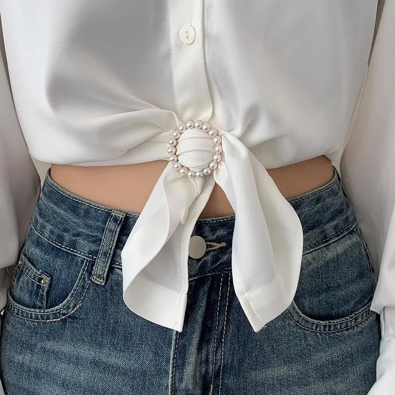 Heart-shaped pearl scarf knot brooch clip on a white fabric knot