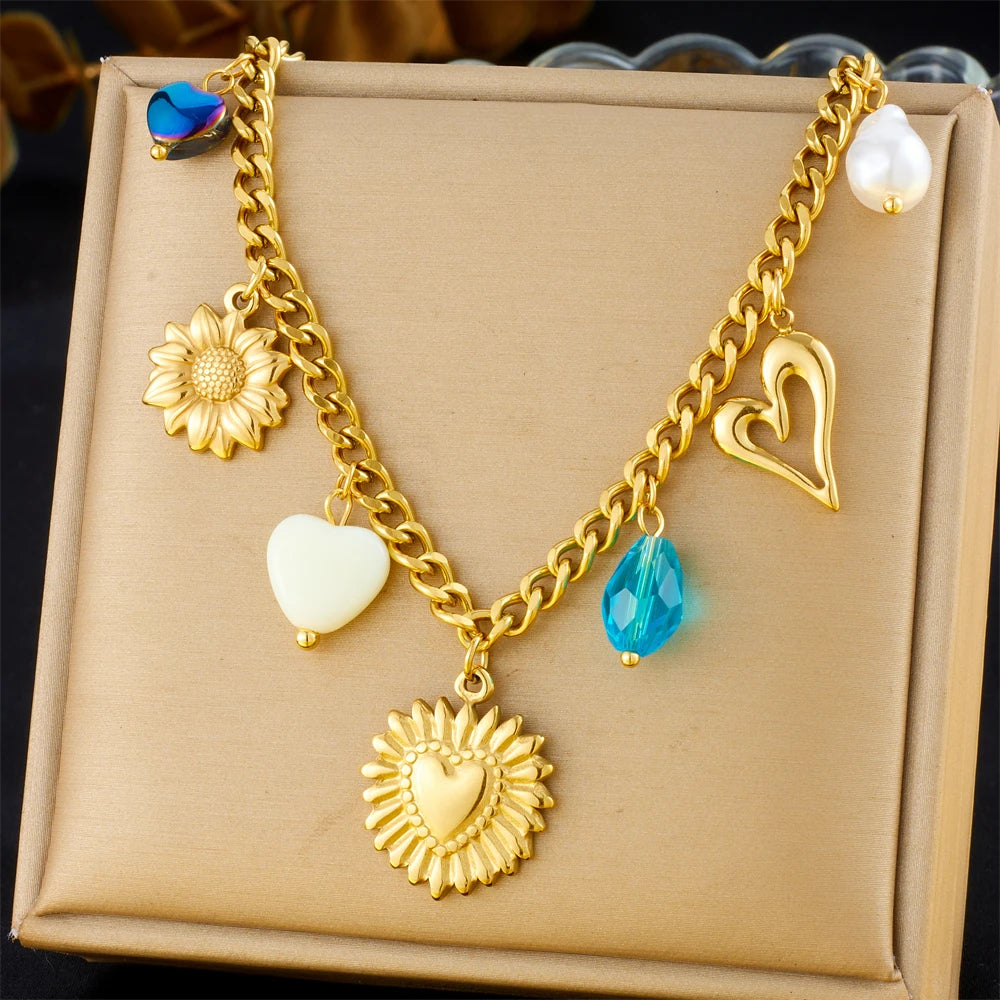 Gold-tone heart and flower multi-pendant necklace with blue drop and white pearl charms