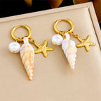 Gold hoop earrings with dangling starfish, pearl beads, and conch drops