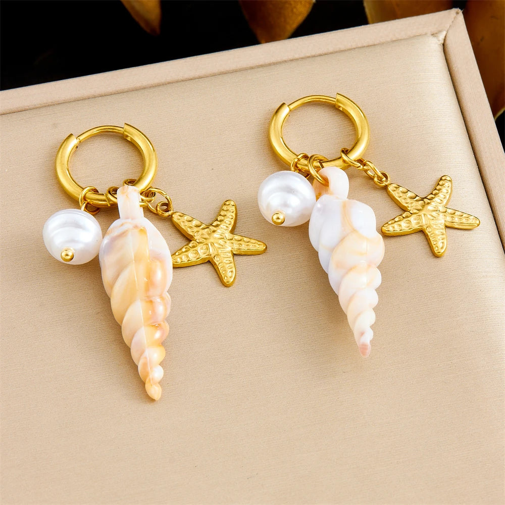 Gold hoop earrings with dangling starfish, pearl beads, and conch drops