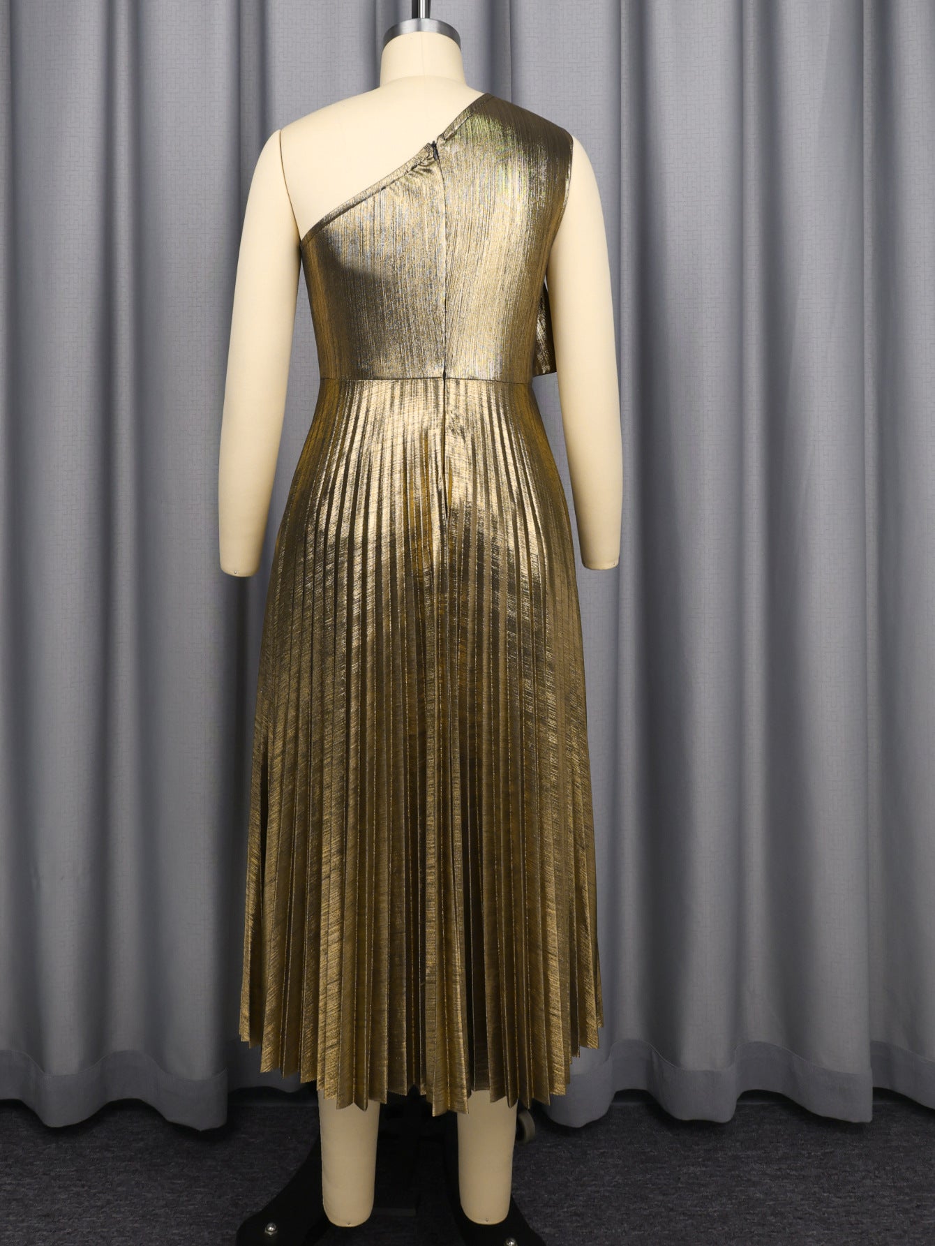 Gold one-shoulder pleated midi dress on mannequin, back view with floral applique