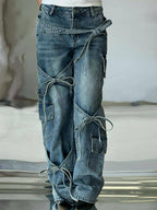 Blue denim utility jeans with wide leg, patch pockets, and knot-tied side panels.