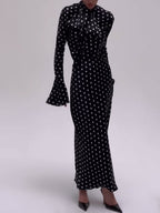 Black polka dot midi dress with flared bell sleeves and bow at high neck