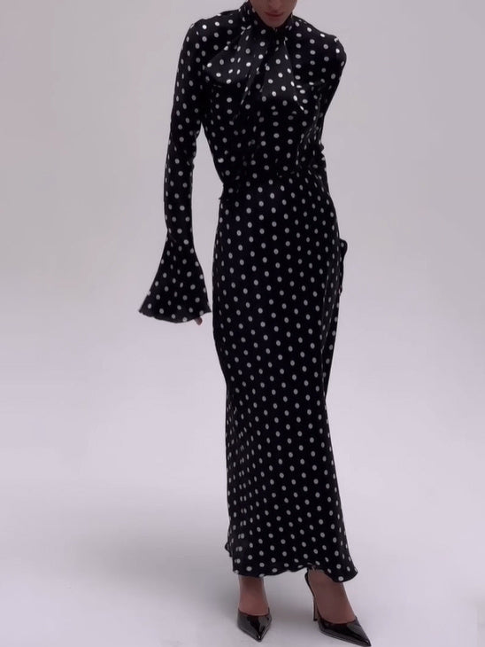 Black polka dot midi dress with flared bell sleeves and bow at high neck