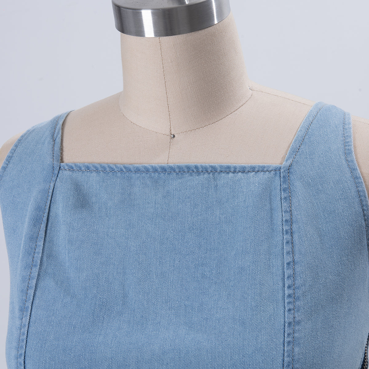Light blue denim off-shoulder square neckline dress with visible seam and structured bodice