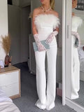 White off-shoulder wide-leg jumpsuit with feather neckline accents and long feathered cuffs