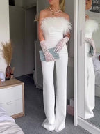White off-shoulder wide-leg jumpsuit with feather neckline accents and long feathered cuffs