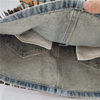 Denim skirt folded view with visible seams, lining, and inner panel edge