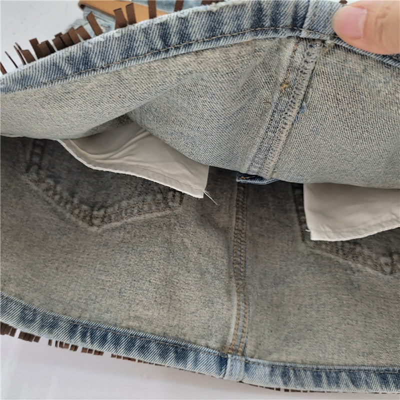 Denim skirt folded view with visible seams, lining, and inner panel edge