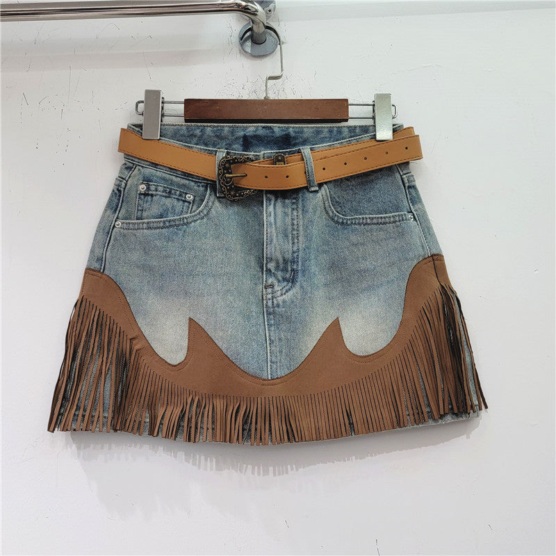 Blue denim tassel skirt with tan belt and scalloped suede panel at hem