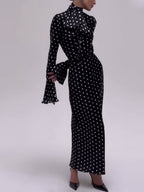 Black polka dot fitted midi dress with long flared sleeves and high neck