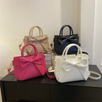 Bow-trimmed small square crossbody handbags in black, rose pink, khaki, and white