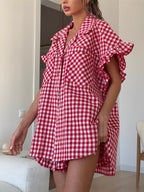 Red gingham ruffled shirt with high-waisted shorts, draped shoulder ruffles