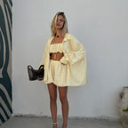 Yellow striped 3-piece lounge set with ruffle crop top, shorts, and open jacket
