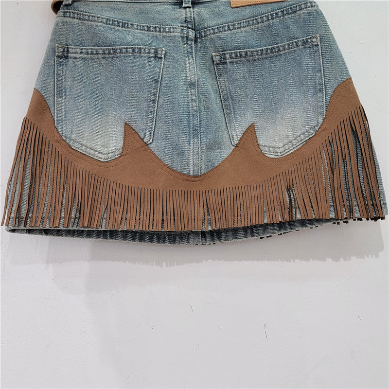 Blue denim skirt with tan scalloped front insert and long fringe tassels