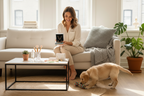 Pet lifestyle care accessories set with bottles on table, dog and woman nearby